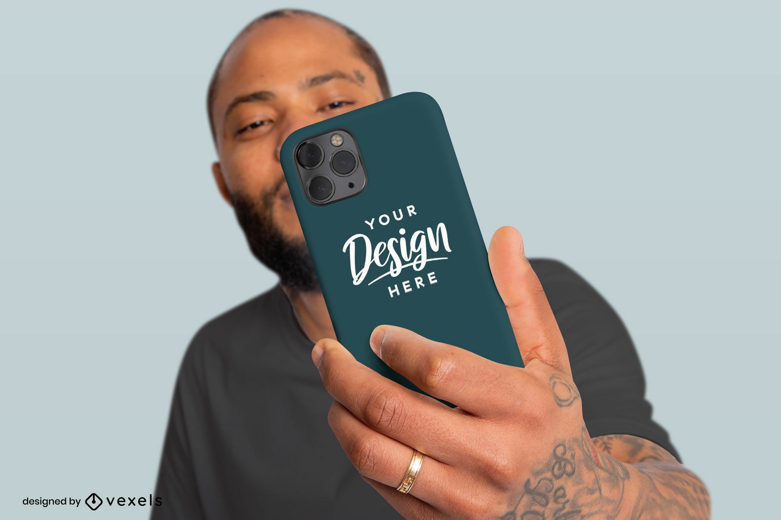 Black man with tattoos holding phone case